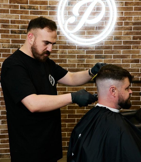 Barber cutting mans hair